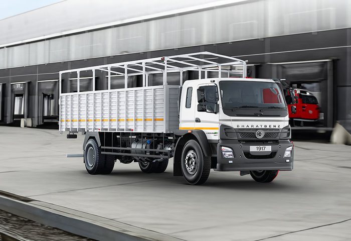 Open body truck with a tarpaulin-covered load